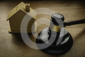 Concept of real estate auction, legal system and property division after divorce. Gavel and house toys on a wooden background