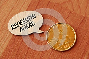 Concept of Recession Ahead write on wooden sign isolated on Wooden Table.