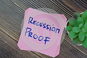 Concept of Recession Proof write on sticky notes isolated on Wooden Table