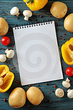 Concept of recipe book on wooden background, space for text