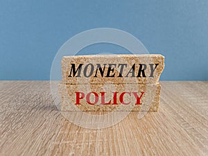 Concept red words Monetary Policy on brick blocks. Ideas for Increase or Decrease interest rates,