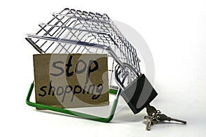 the concept of refusing purchases reasonable consumption an inverted shopping basket with a padlock next to a sign with