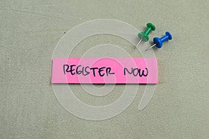 Concept of Register Now write on sticky notes isolated on Wooden Table