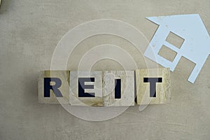 Concept of REIT - Real Estate Investment Fund The wooden Cubes with the word on wooden background