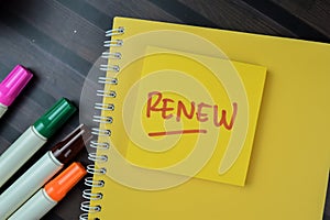 Concept of Renew write on sticky notes isolated on Wooden Table