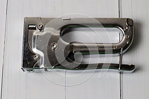 Concept of repair and construction. Construction brackets, stapler on a dark gray wooden background, copy space, macro closeup