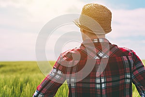 Concept of responsible farming, female farmer in cereal crops field