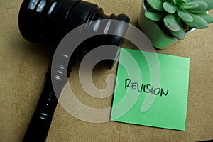 Concept of Revision write on sticky notes isolated on Wooden Table photo