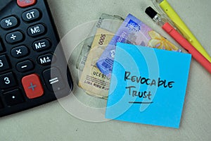 Concept of Revocable Trust write on sticky notes isolated on Wooden Table