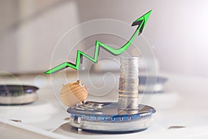 the concept of rising prices for utilities and gas. pigs on the background of coins and growth charts on a gas stove with a flame