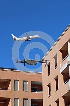 Concept of riskiness of drones for air traffic in front of apartment building photo