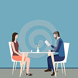 Concept of a romantic or business dinner in a restaurant. Man and woman sit at a table and a guy reads a menu. People have lunch