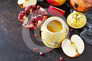 The concept of Rosh hashanah Jewish New Year. Traditional holiday symbols are shofar, honey, apple and pomegranate