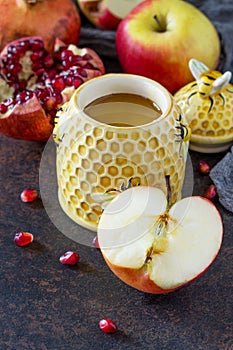 The concept of Rosh hashanah Jewish New Year. Traditional holiday symbols are shofar, honey, apple and pomegranate