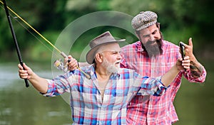 Concept of a rural getaway. hobby. Fly Fishing Time. Camping on the shore of lake. hunting tourism. father and son