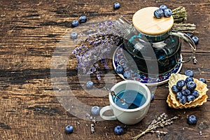 The concept of rustic style tea. Lavender flowers and blueberries. Vintage arrangement