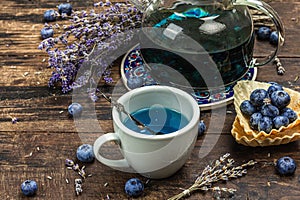 The concept of rustic style tea. Lavender flowers and blueberries. Vintage arrangement