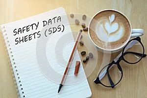 Concept SAFETY DATA SHEETS SDS message on notebook with glasse photo