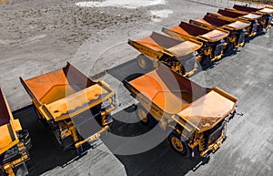 Concept sale of industrial equipment. Parking with big yellow mining truck for coal industry, iron ore and gold. Aerial
