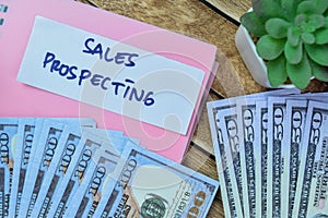 Concept of Sales Prospecting write on sticky notes with dollar isolated on Wooden Table
