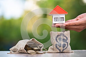Concept of saving money for house, Savings money for buy house and loan to business investment for real estate concept. Invesment