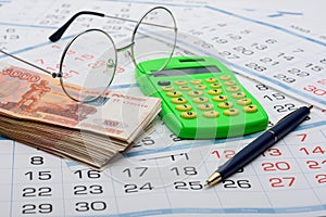 Concept of savings savings for old age, money, pen, calculator and glasses