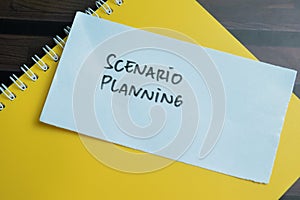 Concept of Scenario Planning write on sticky notes isolated on Wooden Table