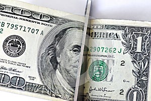 Concept scissors cut the hundred dollar and one dollar bill on white background