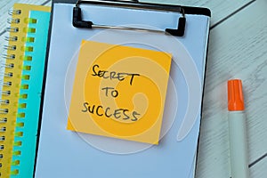 Concept of Secret To Success write on sticky notes isolated on Wooden Table