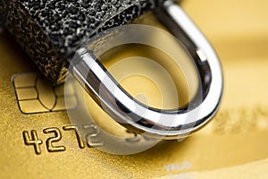 Concept of security payment. Lock on gold credit card