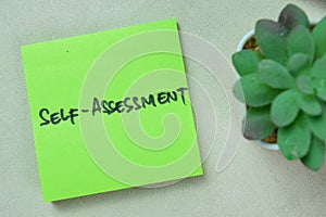 Concept of Self-assessment write on sticky notes isolated on Wooden Table