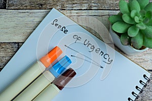 Concept of Sense of Urgency write on book isolated on Wooden Table