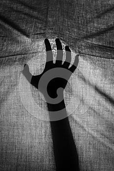 The concept of the shadow of hand behind cloth