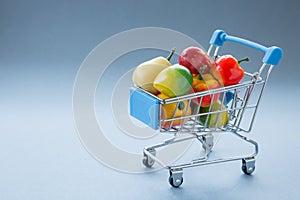 Concept shopping trolley or cart full of fresh fruit and veg