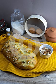 Concept shot of breads on the wood table, with egg, flour, seeds and nuts