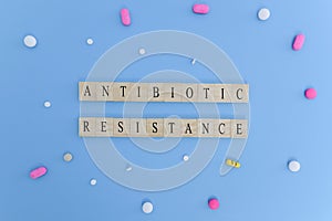 Concept showing of Antibiotic resistance with medicines or pills in wooden block letters