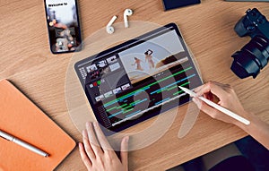 Concept of simple operation of blogger and vlogger, hand using digital pen on video editor works with footage on tablet.
