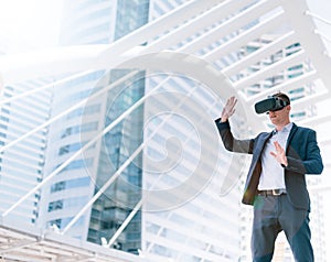 Concept Simulation Business, Smart businessman in a suit wear vr goggles with city town background..