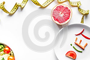 Concept slimming diet fresh vegetables on white background top v