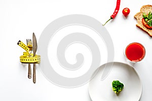 Concept slimming diet fresh vegetables on white background top view
