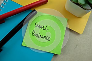 Concept of Small Business write on sticky notes isolated on Wooden Table