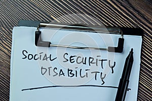 Concept of Social Security Disability write on paperwork isolated on Wooden Table