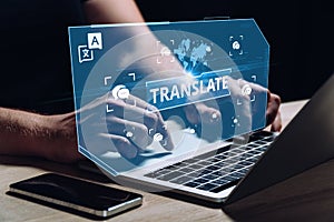 The concept of software for translation between different languages. The person works at the computer.