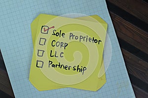 Concept of Sole Proprietor write on sticky notes isolated on Wooden Table