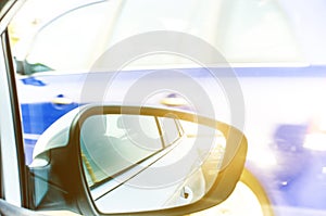 Concept of speed. Car driving on the road. Reflection in a car mirror.Rear view mirror reflection. Blurry background.