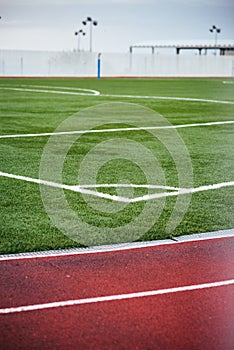 Concept: Sport. Detail of the corner of the soccer field next to the athletics track