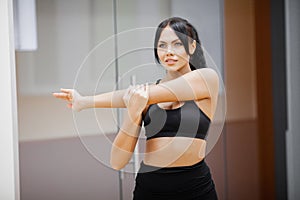 Concept of sport and healthy lifestyle. Cute brunette working out at a gym