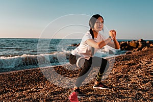 Concept of sport and healthy lifestyle. A woman in sports clothes is engaged in an exercise with an elastic band, a shaker lies