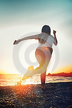 The concept of sport and running. A woman in sportswear starts for a run. Rear and bottom view. In the background, the sky and the