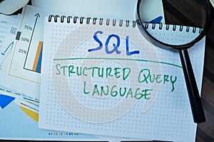 Concept of SQL - Structured Query Language write on book isolated on Wooden Table
